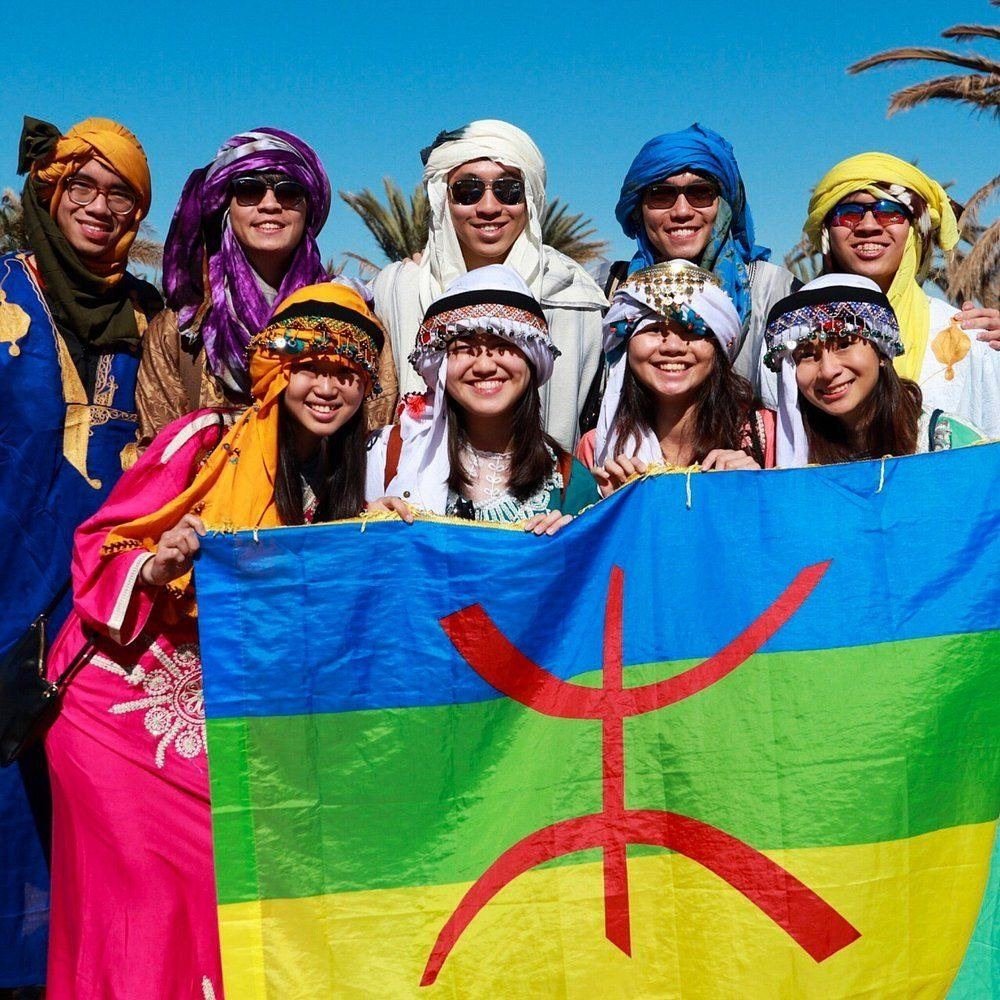 Our travellers in Amazigh dress with the Amazigh flag